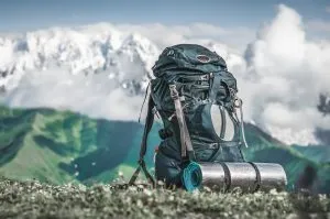 Ryggsäck och liggunderlag för turister mot en bakgrund av berg